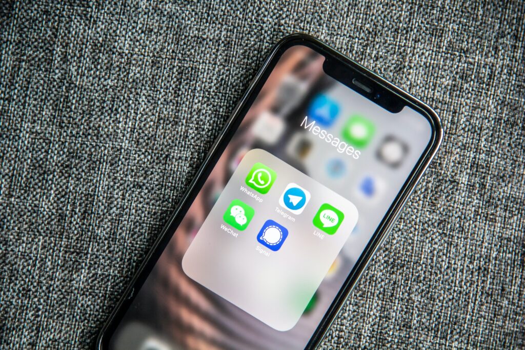 An iPhone with WhatsApp icons and online status tracker on it.