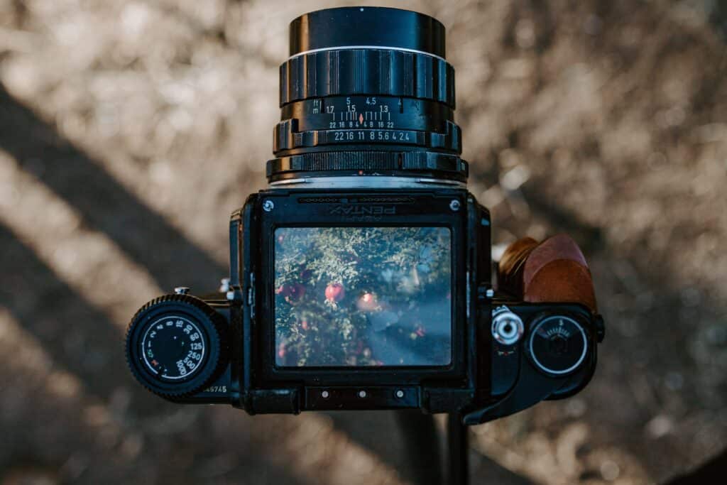 A black and white photograph of a camera with a viewfinder used to monitor WhatsApp activity.